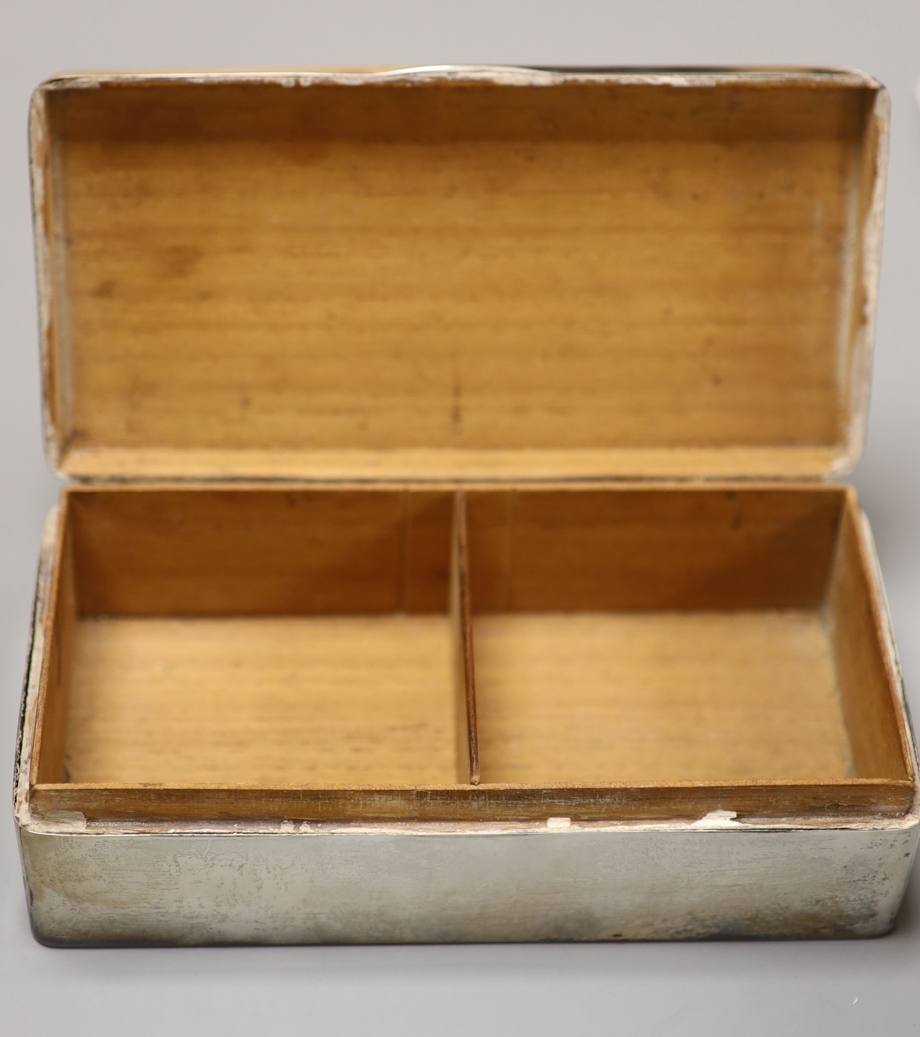 Three silver mounted cigarette cases, largest 17.9cm.